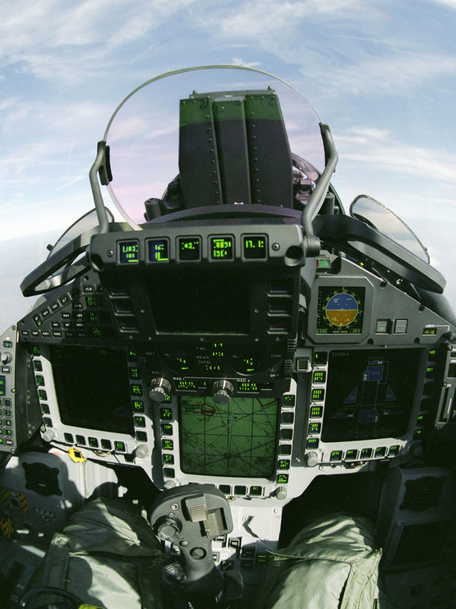 A Eurofighter cockpit with similar green monochrome displays and physical dials/buttons